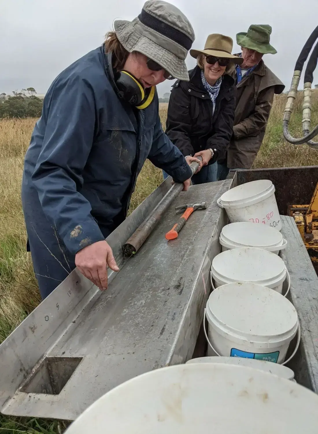 Getting the soil cores out of the tube can be tricky business! From left to right: Kirsty Yeates, Liz Clarke and Martin Royds.