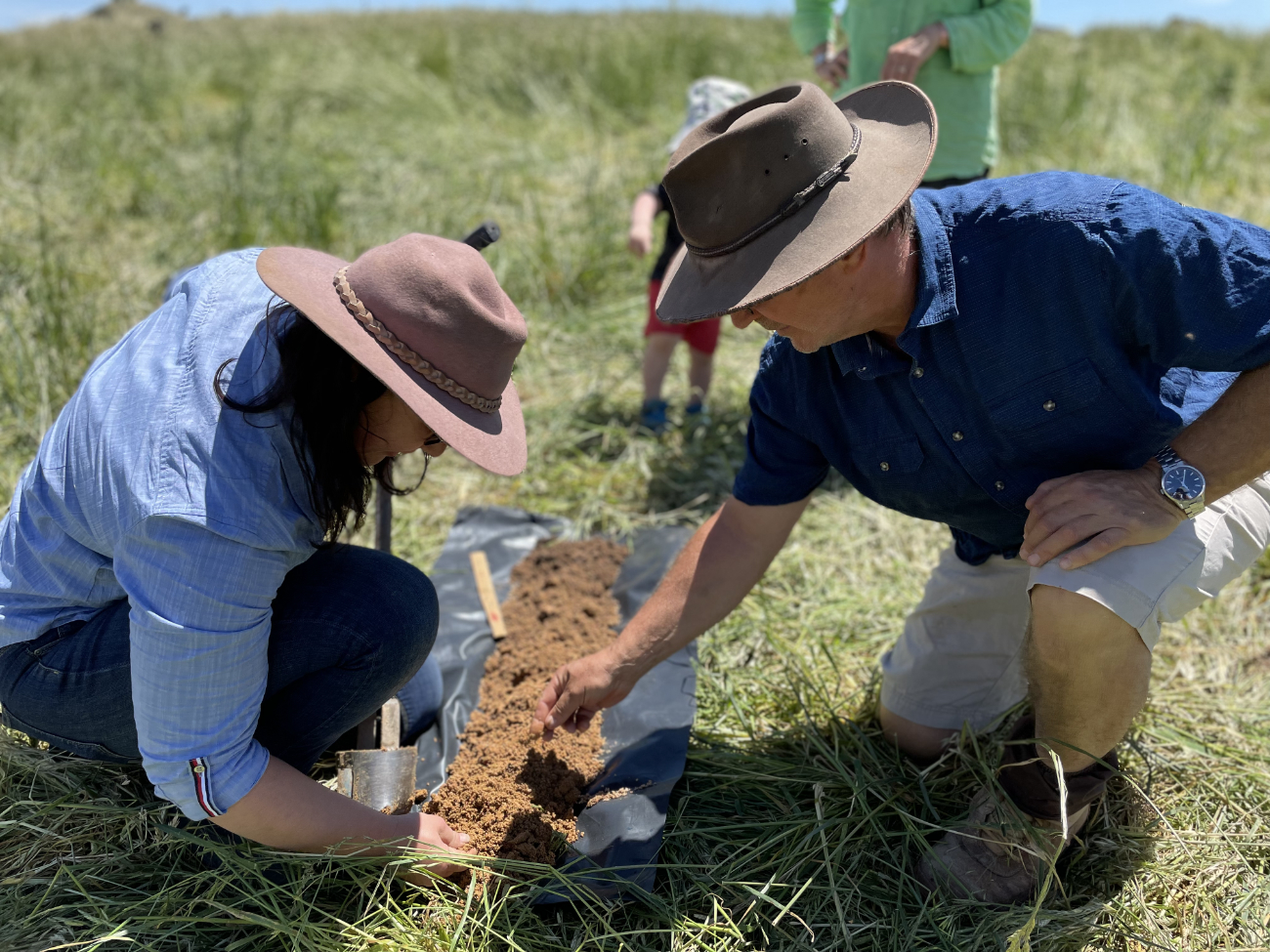 John Lilleyman inspecting a soil sample with Soils for Life's Daniela Carnovale